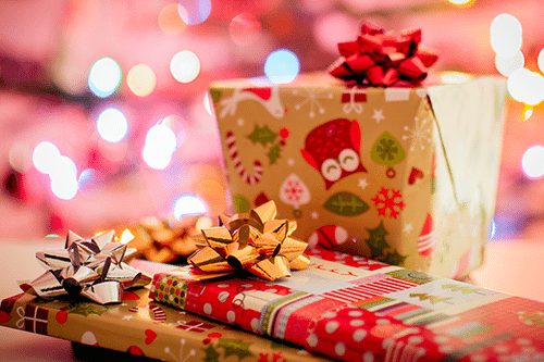 Christmas gifts with red and gold wrapping paper and bows
